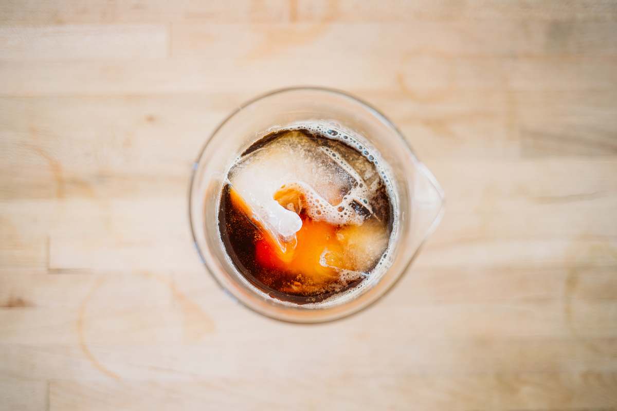 ice tea clear glass pitcher with red and black labeled liquid cola